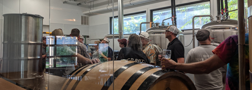 Arkansas Brewers Guild members touring the inside of a brewery.